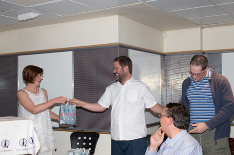 Gwenda Thomas presenting gifts to Thomas Slingsby and Nicholas Lindenberg (GIS Consultants) on behalf of the Geospatial project team. Dr Kevin Winter (EGS) in the foreground.