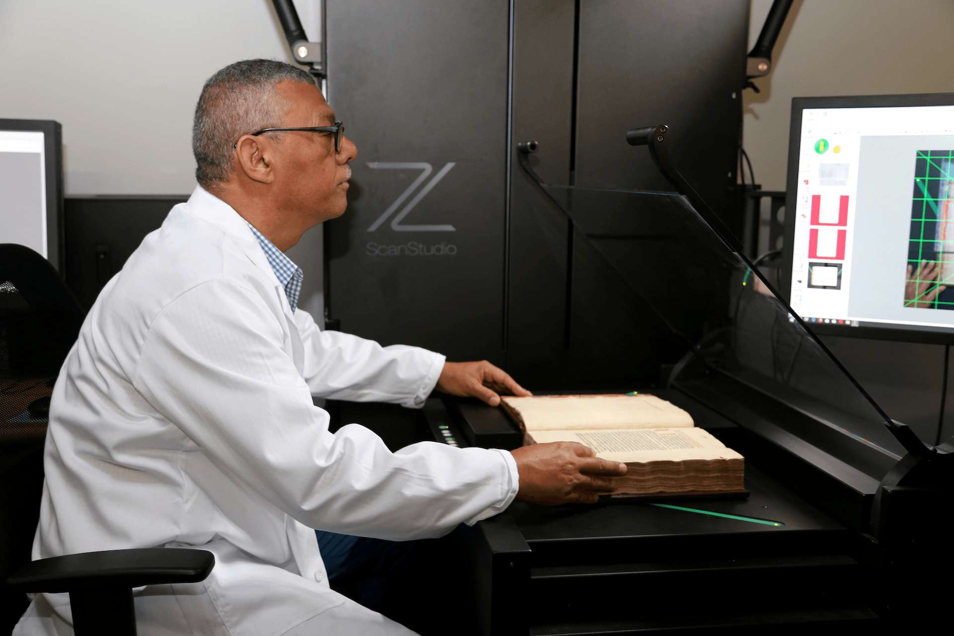 Mark Hanmer aligns book for scanning under glass