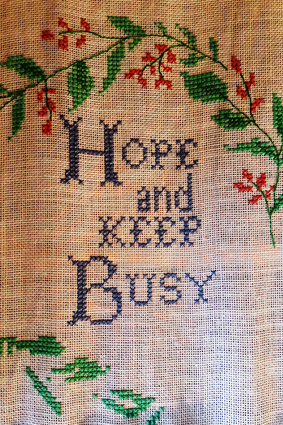 Embroidery with sowed writing hope and keep busy