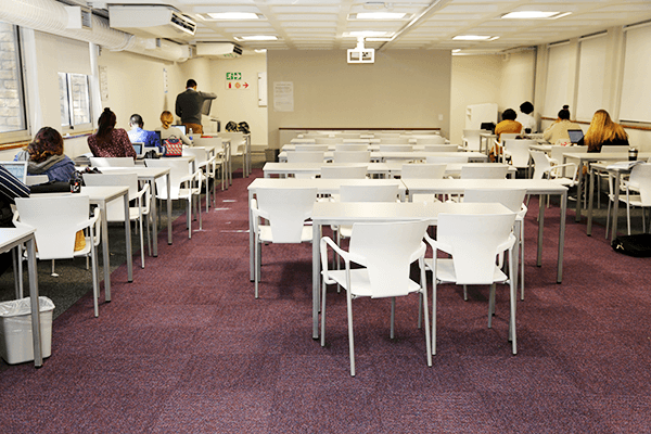 Students studying at desks inside Impilo Junction