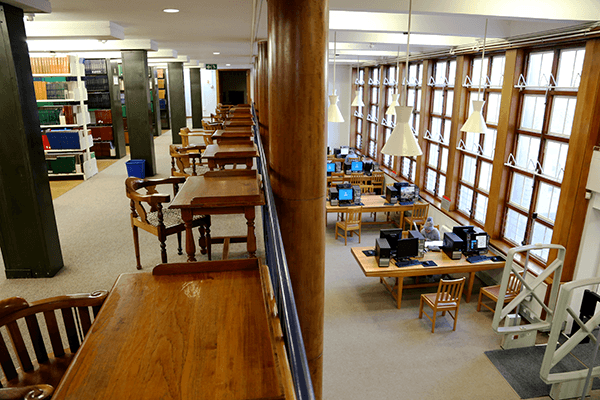 Upstairs seating overlooking main reading room with desks and PCs at Health Sciences Library