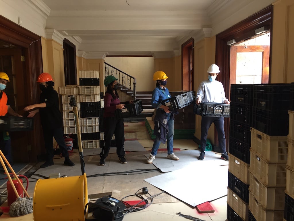 Volunteers form a human chain to transfer crates of books from Jagger Library. Photo by Dilshaad Brey