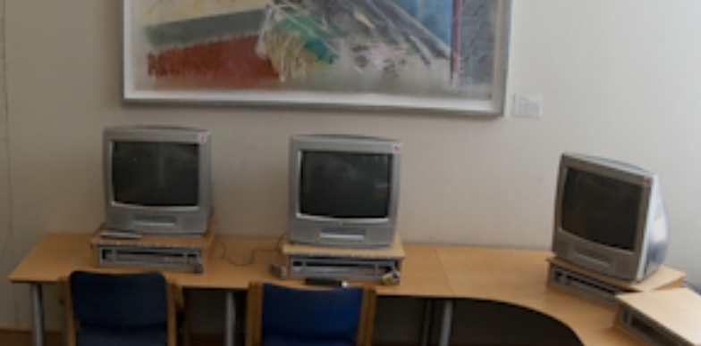 Three TVs with built-in VHS requipment on desks