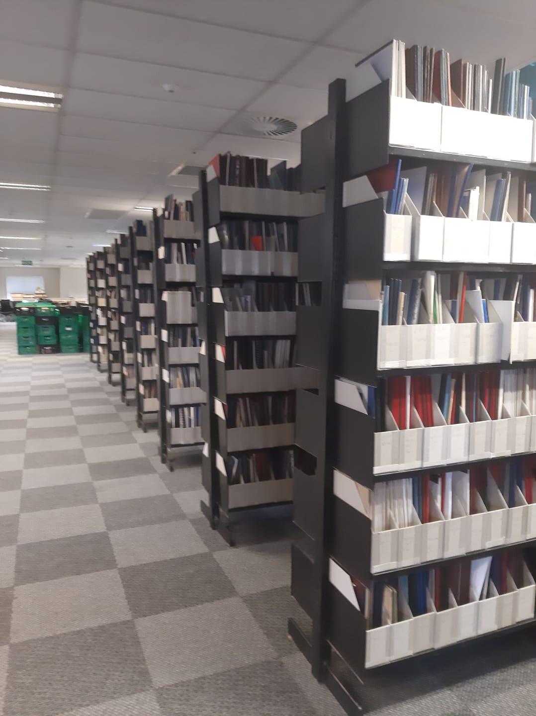 Rowsof book stacks of pamphlets reshelved