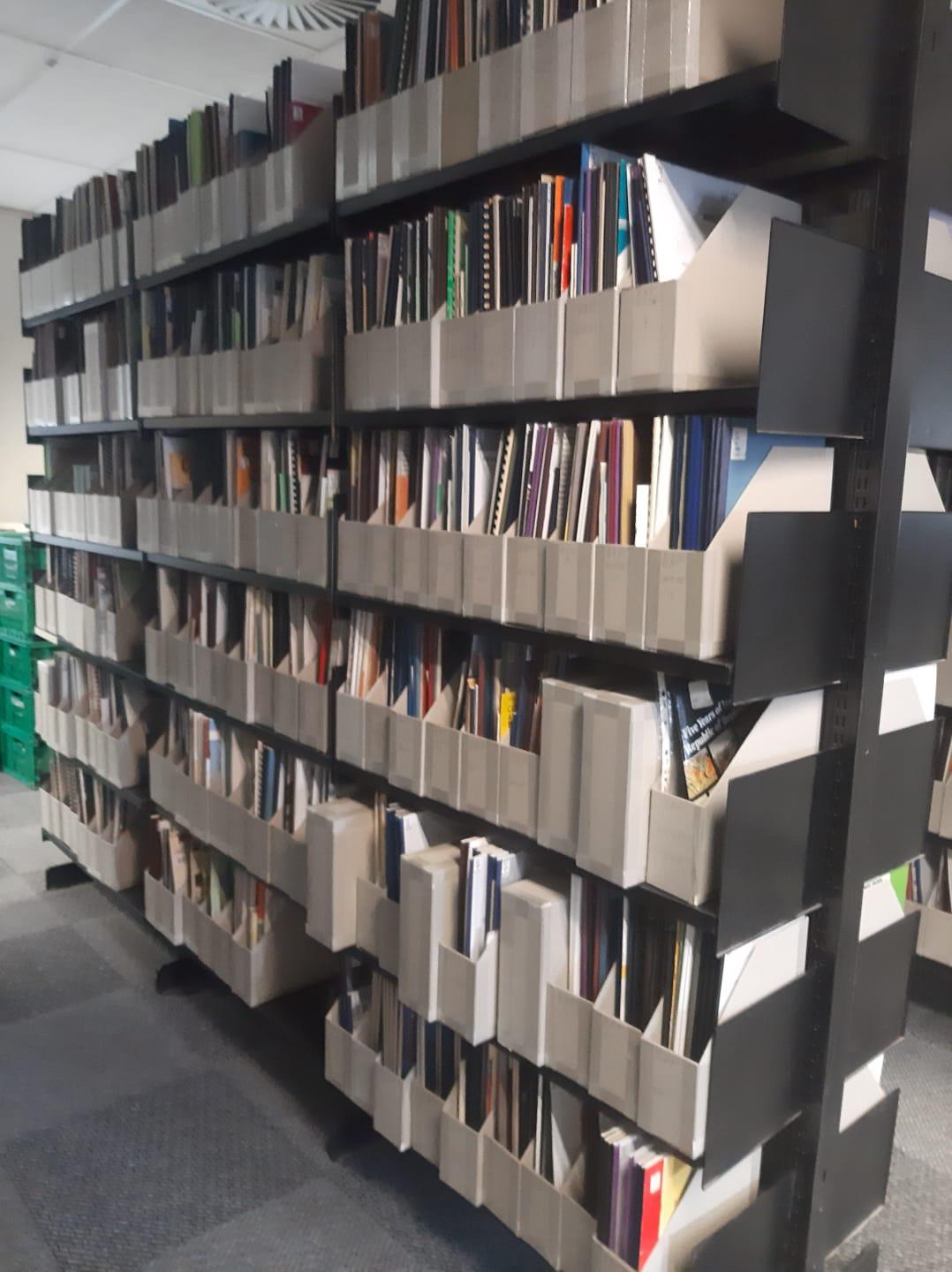 Book stack of pamphlets reshelved inside boxes