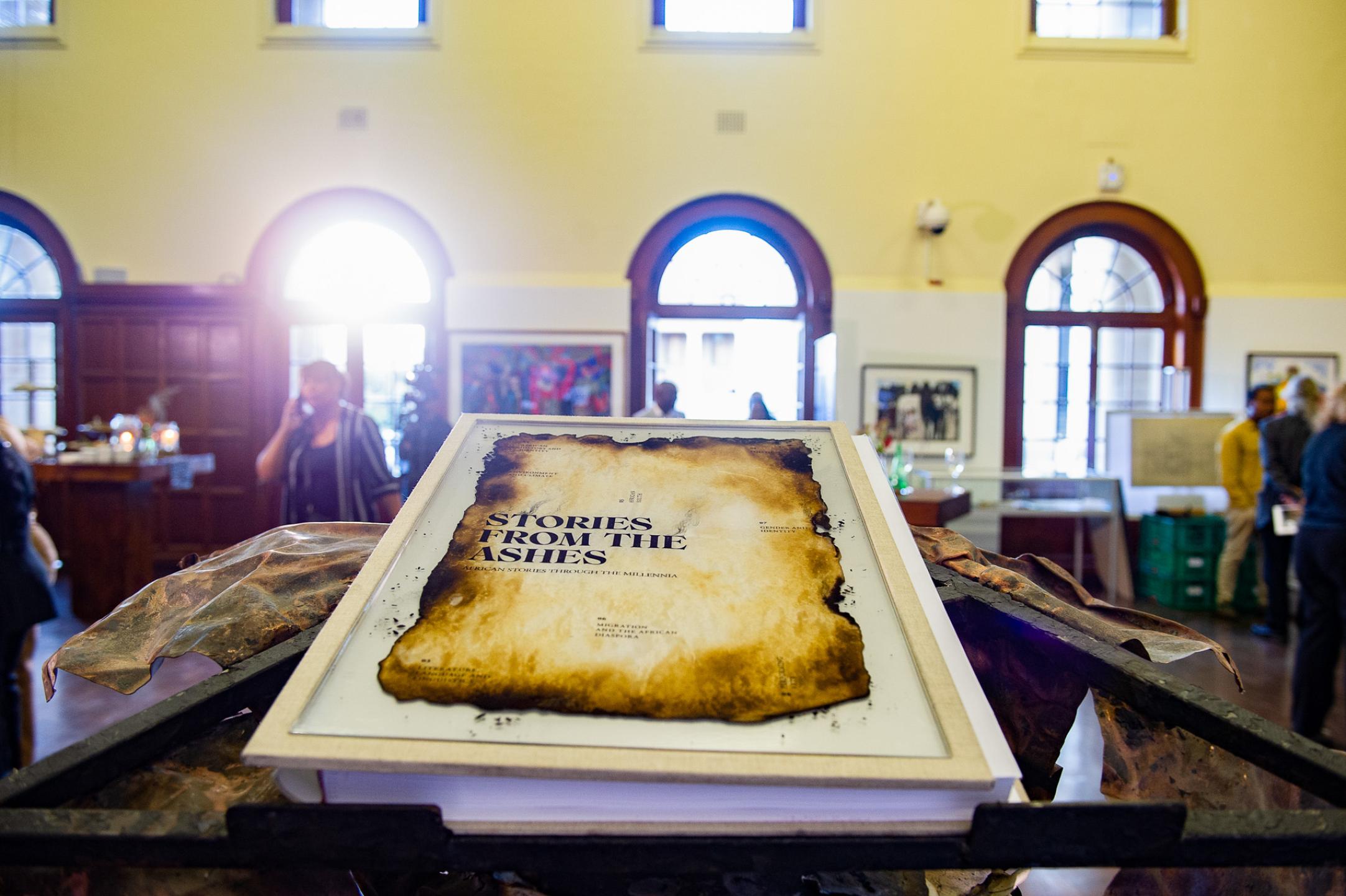 Stories from the Ashes book on display inside Molly Blackburn foyer. Resting on bespoke metal book stand 