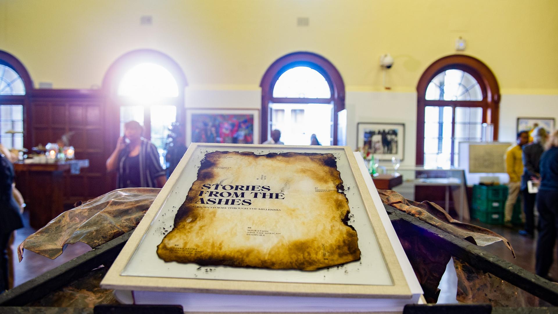 Stories from the Ashes book on display inside Molly Blackburn foyer. Resting on bespoke metal book stand 