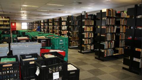 Recovered published collections in rows of bookstacks at Maitland House