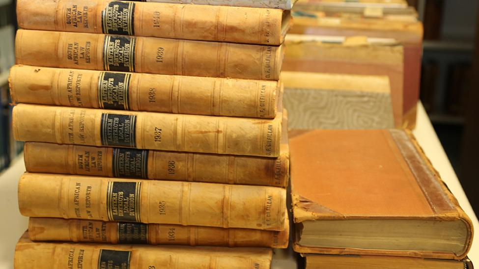 A stack of Old South African Law Report books on a table