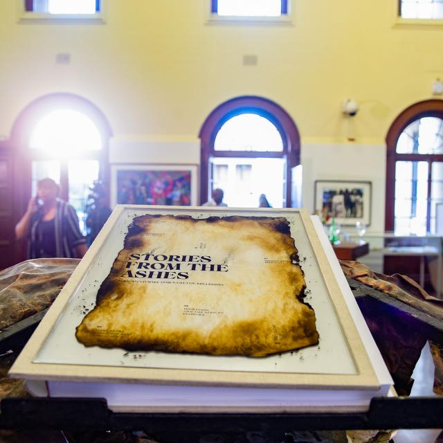 Stories from the Ashes book on display inside Molly Blackburn foyer. Resting on bespoke metal book stand 