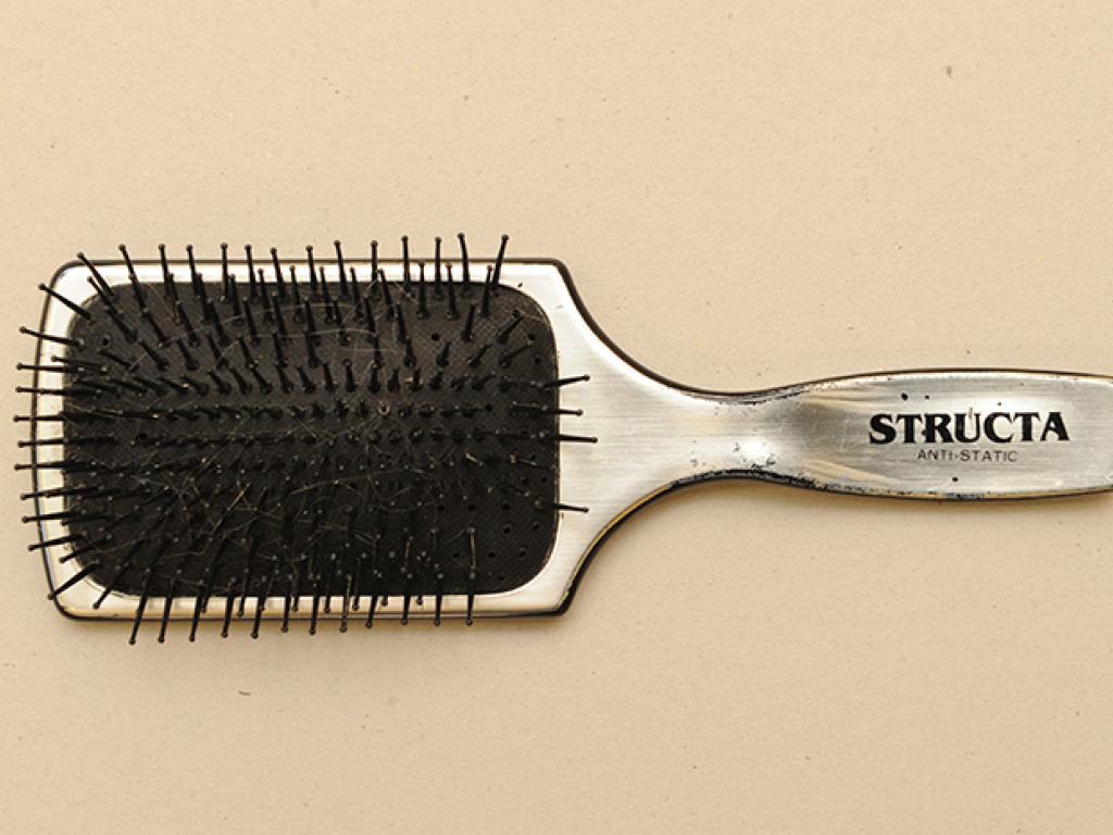 Photo of a sliver paddle brush used by Jack Simons to brush his wife's long hair