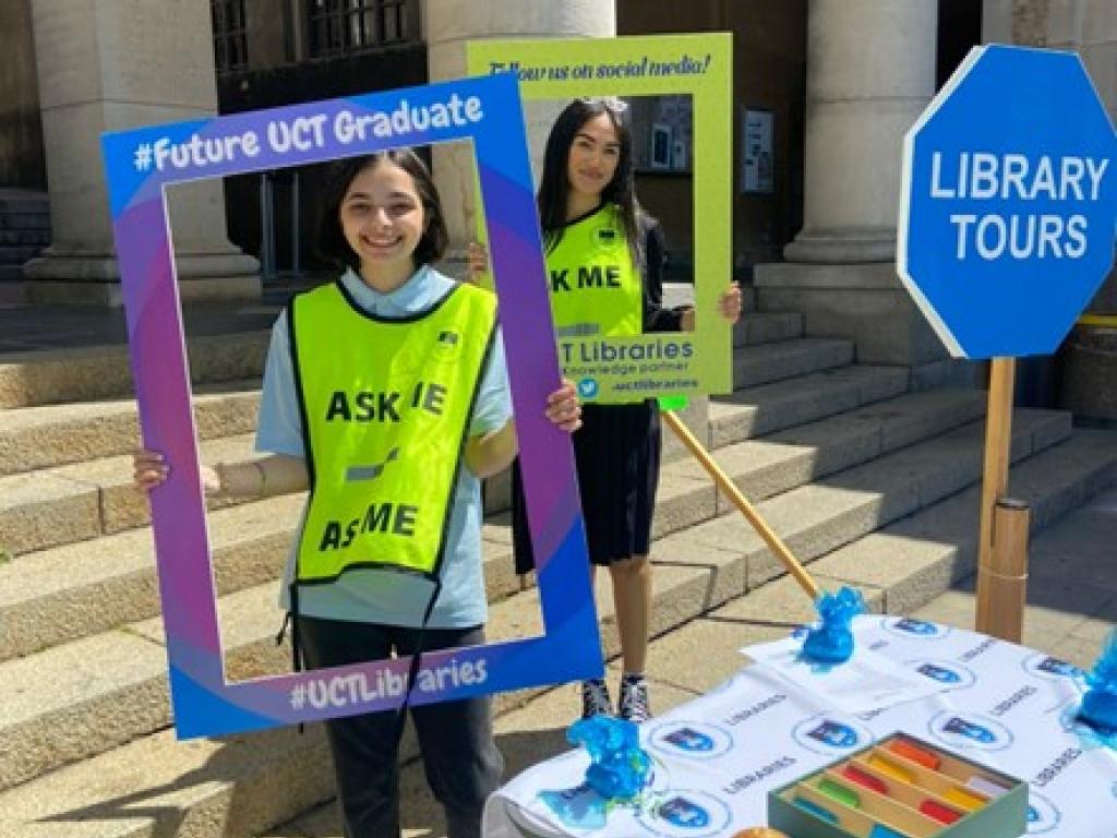 Two Library Buddies pose with UCT Libraries #Future UCT Graduate Day Photo Frames.