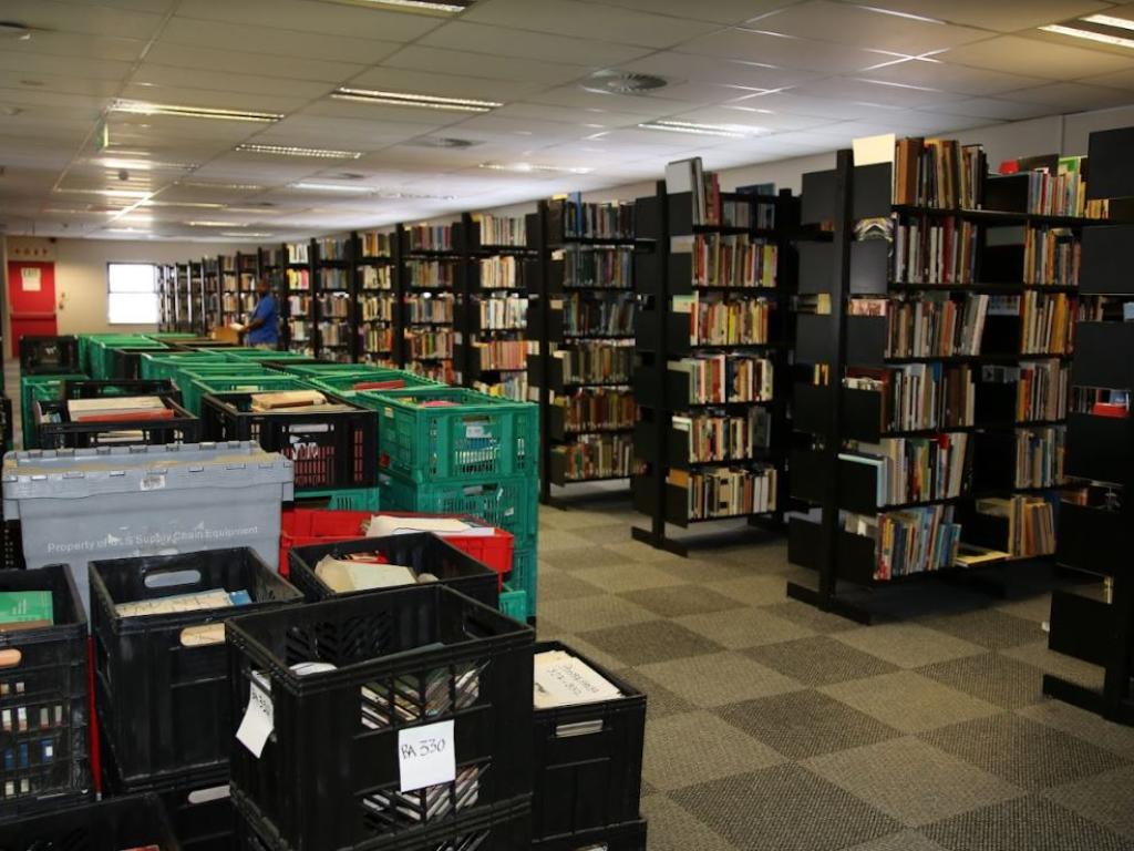 Recovered published collections in rows of bookstacks at Maitland House