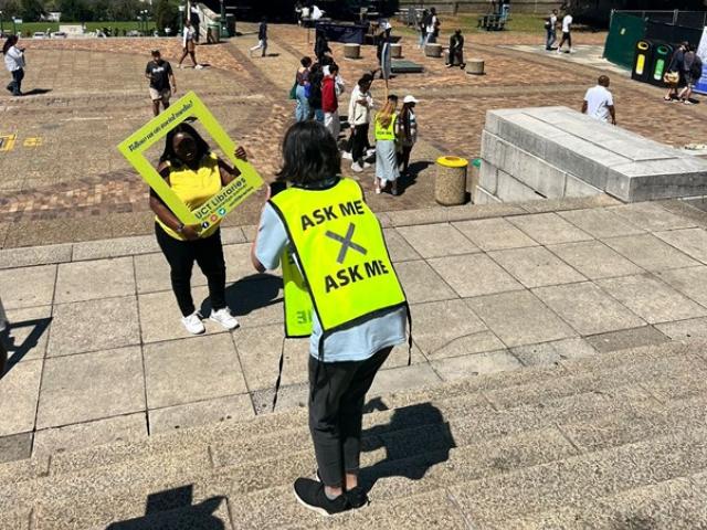 Library Buddy, Iqra Faki snaps a photo for an excited prospective student