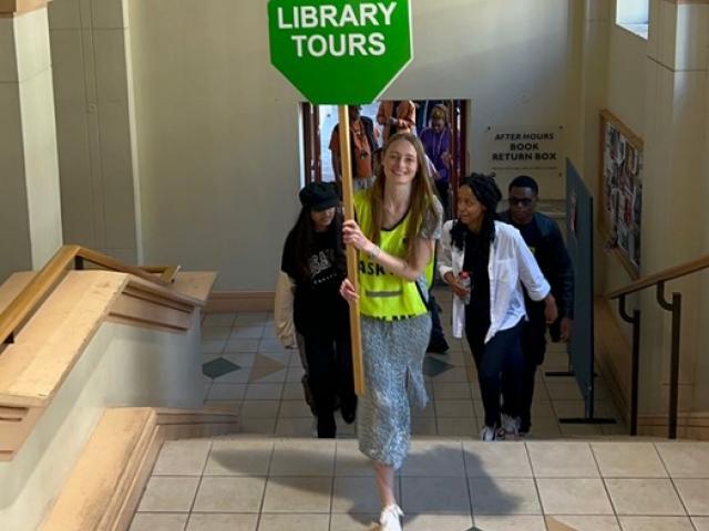 Library Buddy Michaela de Waal leads a tour group into the library.