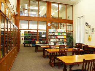 Long desks with chairs inside reading room of Bolus Library