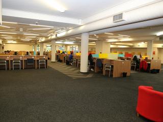 Students studying inside main reading room of Law Library