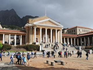 View from University Avenue of Chancellor Oppenheimer Complex with Sarah Baartman Hall centered on a mountain backdrop