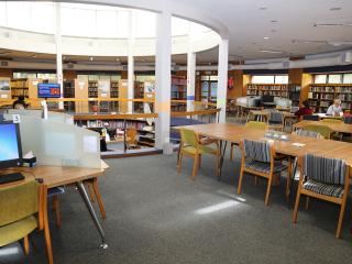 Reading room with long tables and a PC cluster